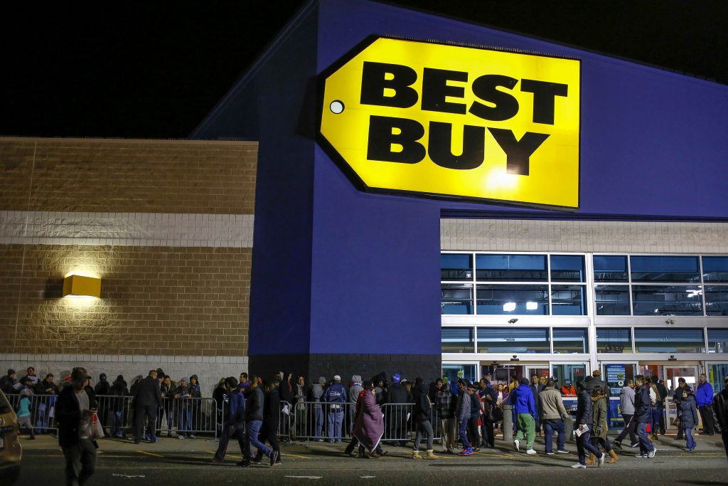 Shoppers enter and leave the Best Buy electronics store on the Thanksgiving Day holiday in Westbury, New York