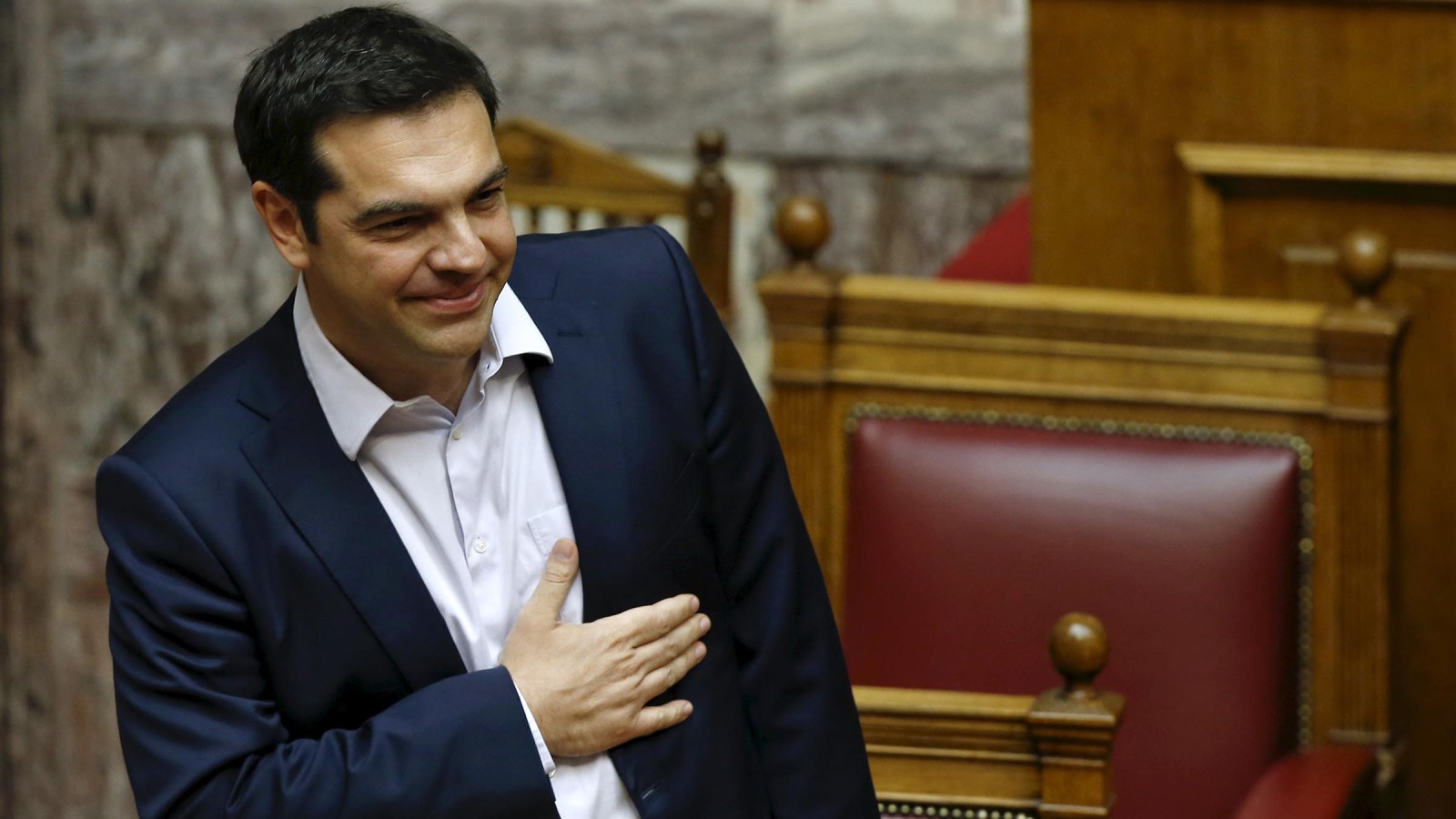 Greek PM Tsipras acknowledges applause by his party's lawmakers during a parliamentary session in Athens