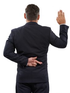 Rearview of a mature man swearing an oath with his fingers crossed behind his back